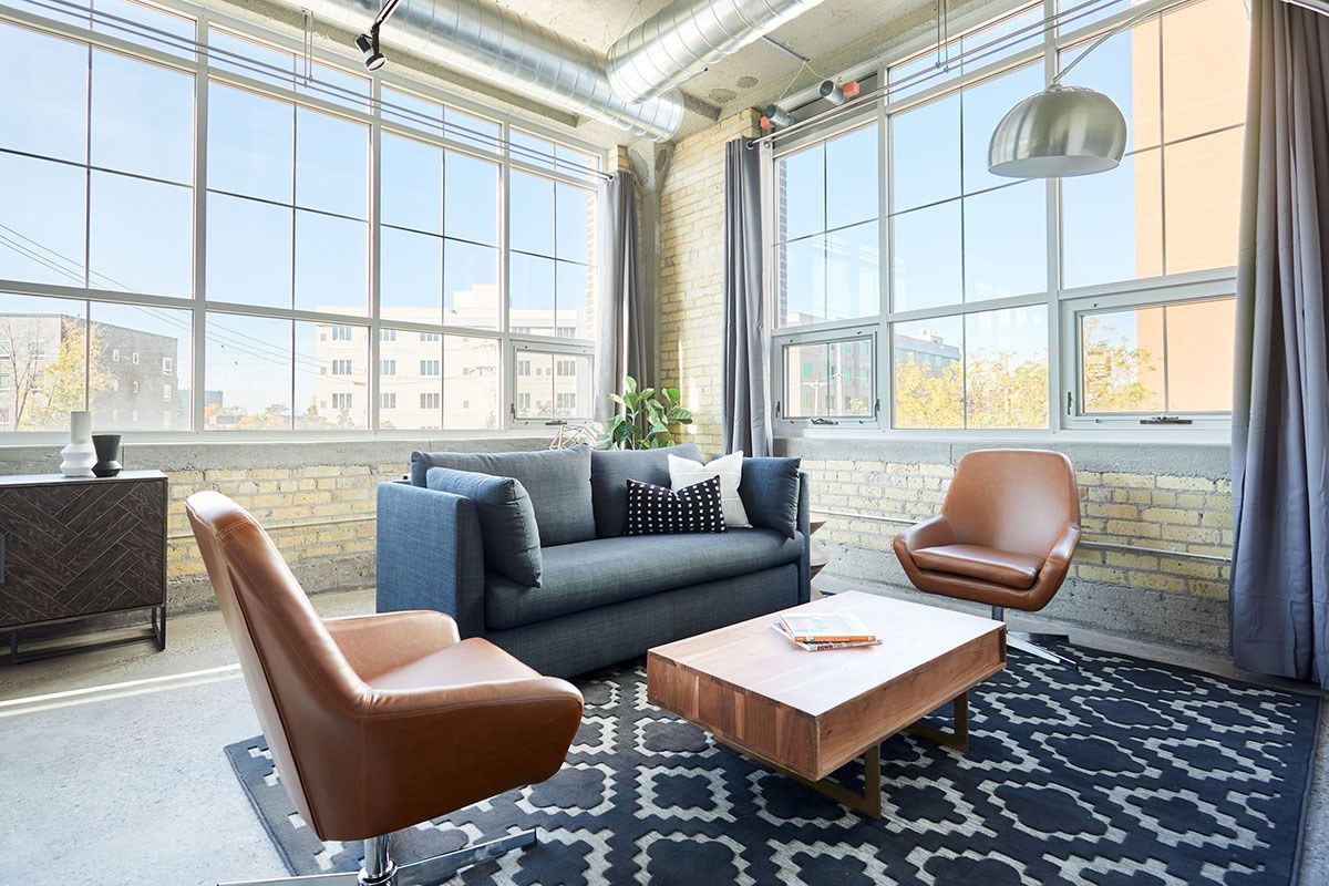 Max Minneapolis apartments unit with living room furniture, rug, and large windows