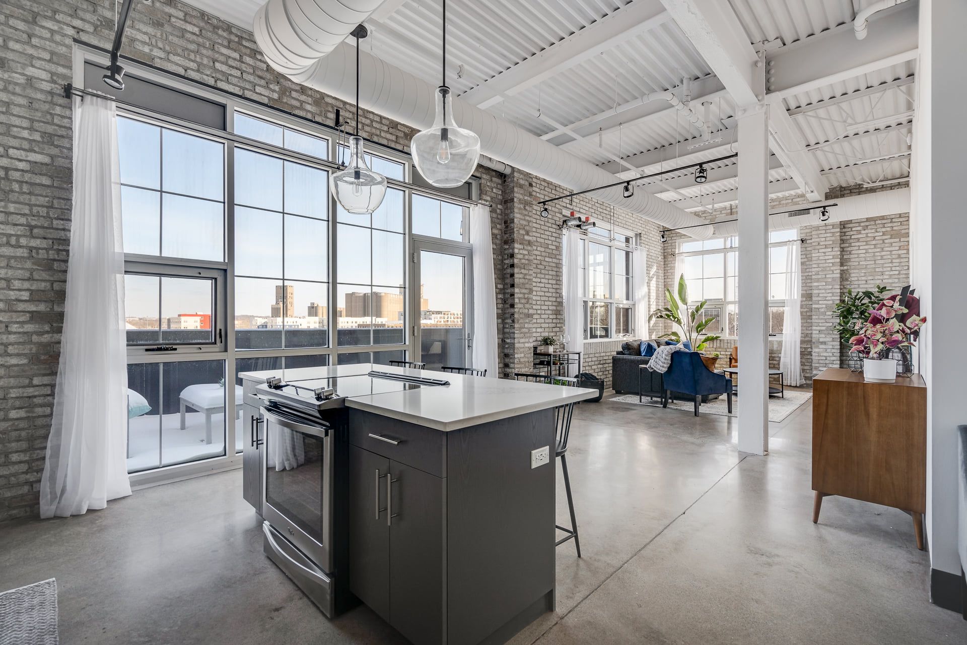 Downtown Minneapolis apartment kitchen and living area with kitchen island and large windows