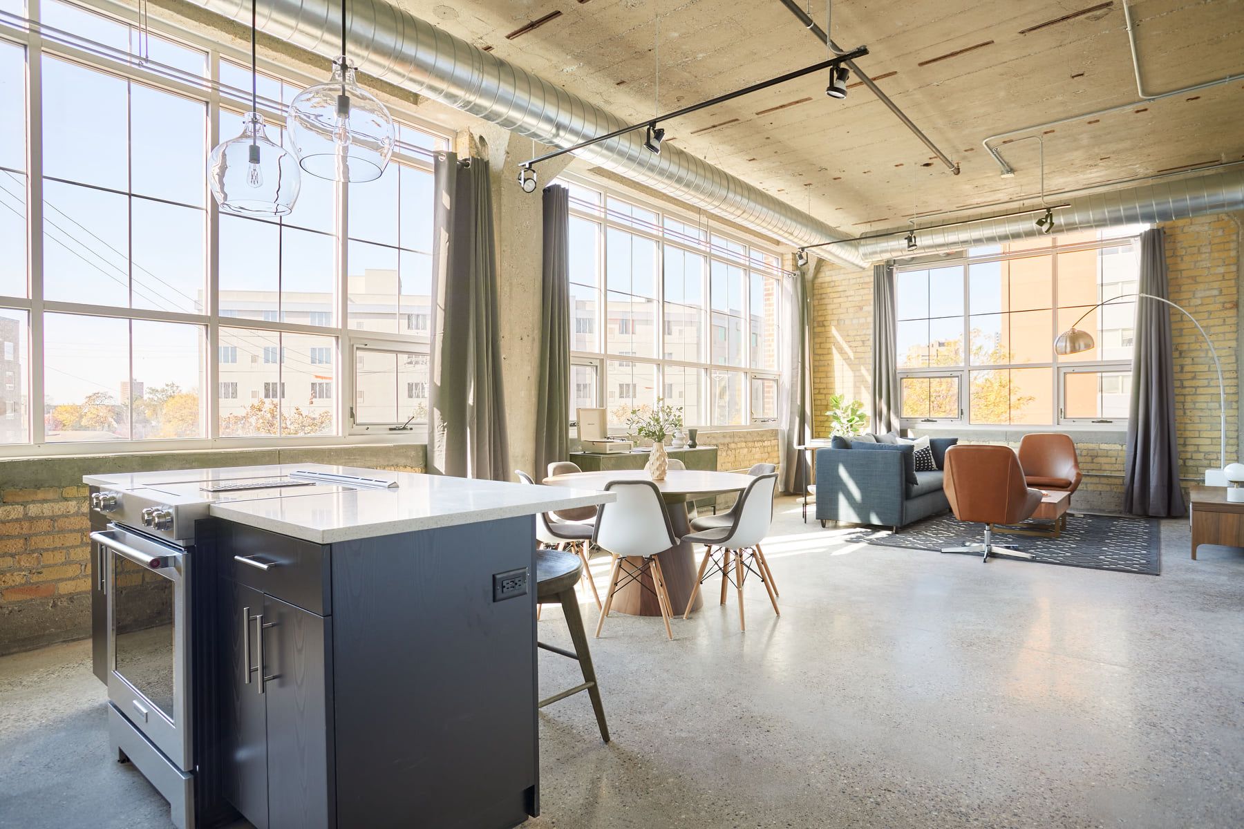Area with booths and desks to work inside MAX Minneapolis apartments