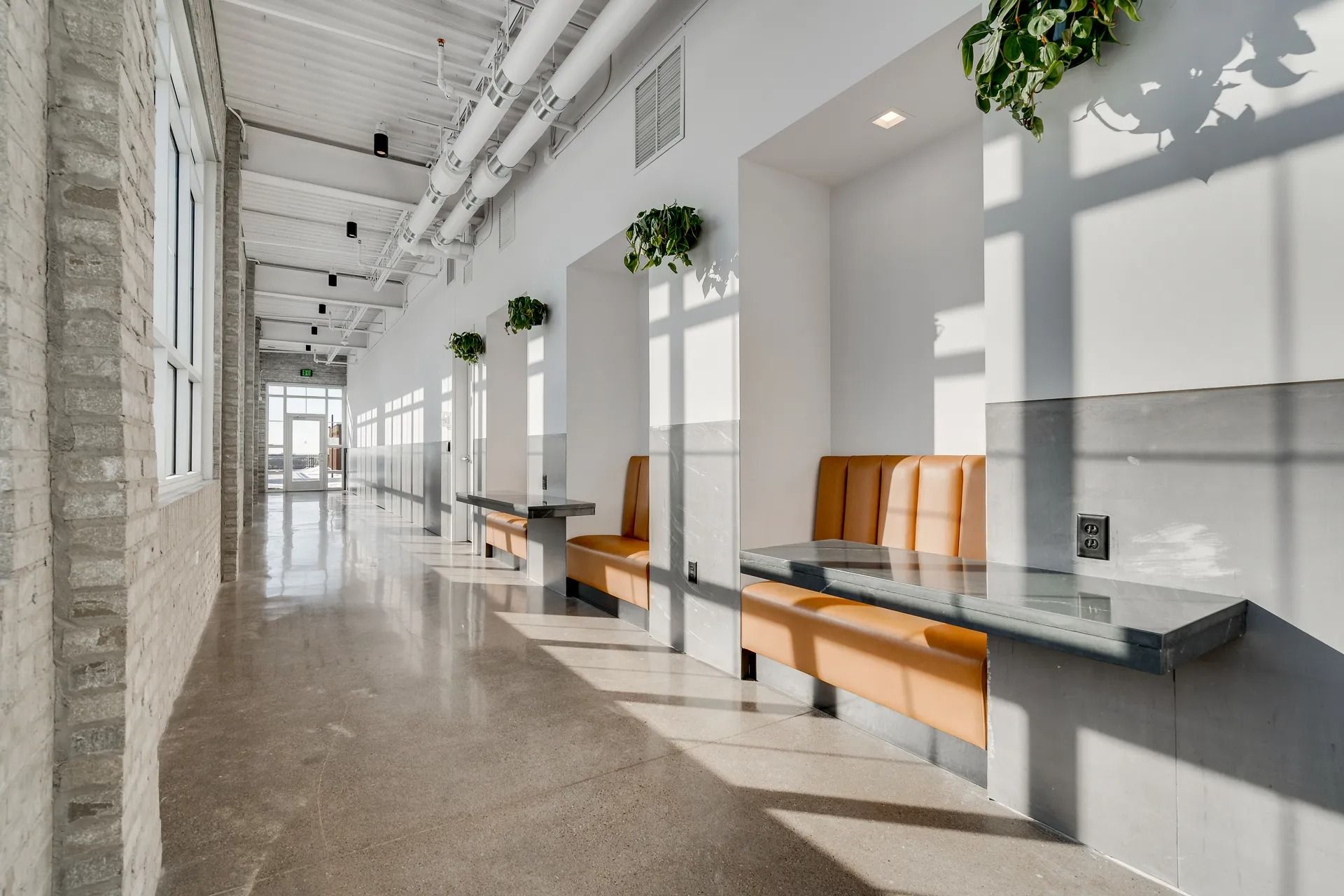 Area with booths and desks to work inside MAX Minneapolis apartments