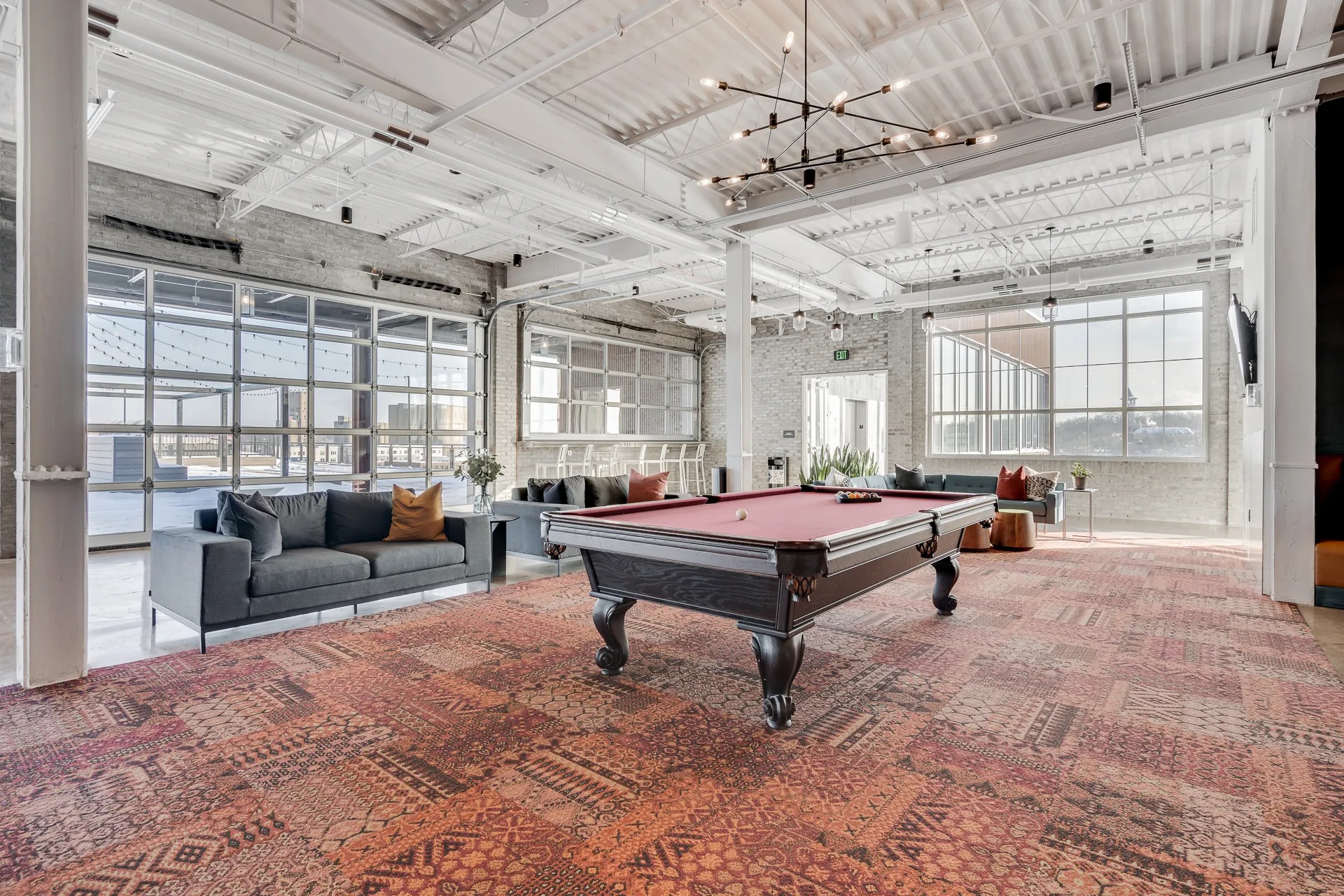 Club room for MAX apartments residents with billiards table and lounge seating
